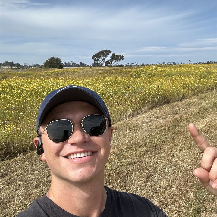 Jared Harman in sunglasses in a grassy field