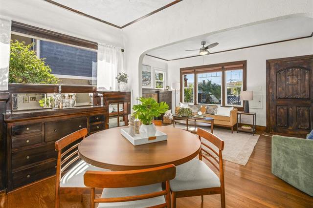 Craftsman dining room with a round table, a built-in buffet and wood doors