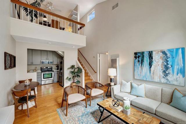 Two-story loft living room with a balcony and a staircase